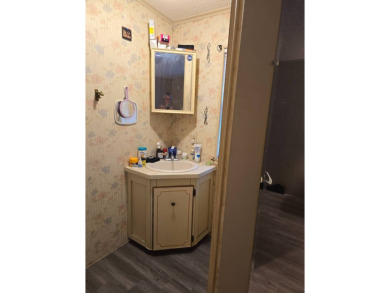 This home is located in the 55+ mobile home community of Anglers on Anglers Green Golf Course in Florida - for sale on GolfHomes.com, golf home, golf lot