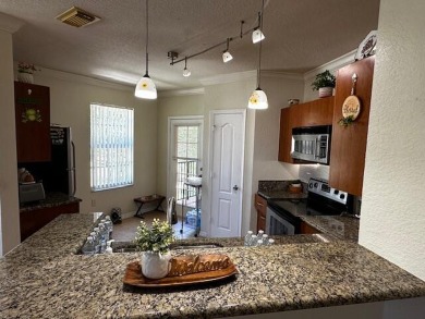 2 bedrooms 2-bathroom apartment. Futures a kitchen with granite on Nicholas Golf Club in Florida - for sale on GolfHomes.com, golf home, golf lot