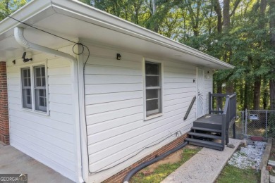 This charming 3-bedroom, 2-bath, 4-sided brick ranch in on Browns Mill Golf Course in Georgia - for sale on GolfHomes.com, golf home, golf lot