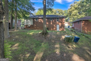 This charming 3-bedroom, 2-bath, 4-sided brick ranch in on Browns Mill Golf Course in Georgia - for sale on GolfHomes.com, golf home, golf lot