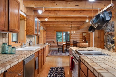 This charming log home, nestled in the trees and perched above on Big Sky of Montana Golf Course in Montana - for sale on GolfHomes.com, golf home, golf lot