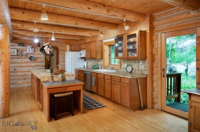 This charming log home, nestled in the trees and perched above on Big Sky of Montana Golf Course in Montana - for sale on GolfHomes.com, golf home, golf lot