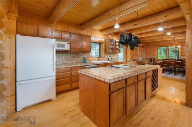 This charming log home, nestled in the trees and perched above on Big Sky of Montana Golf Course in Montana - for sale on GolfHomes.com, golf home, golf lot