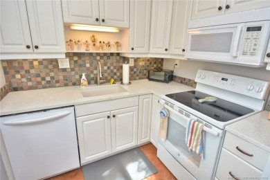 Step into this cozy, beachy-theamed condo and you won't want to on Pine Lakes Golf Club in Florida - for sale on GolfHomes.com, golf home, golf lot