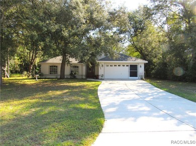 Charming three-bedroom, two-bathroom home featuring a two-car on Pine Ridge Community Golf and Country Club in Florida - for sale on GolfHomes.com, golf home, golf lot