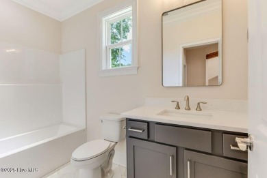 This brand new Riptide home with stunning setting and finishes on Sea Trail Golf Resort in North Carolina - for sale on GolfHomes.com, golf home, golf lot