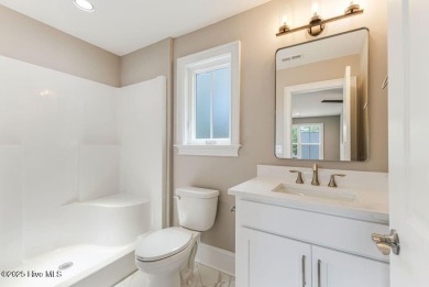 This brand new Riptide home with stunning setting and finishes on Sea Trail Golf Resort in North Carolina - for sale on GolfHomes.com, golf home, golf lot