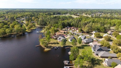 Spectacular waterfront home on Lake Arbu w/ panoramic water on Players Course At Wyboo Plantation in South Carolina - for sale on GolfHomes.com, golf home, golf lot