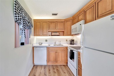 Light and bright 1BR/1.5BA corner unit in a 55+ development on The American Golf Club in Florida - for sale on GolfHomes.com, golf home, golf lot