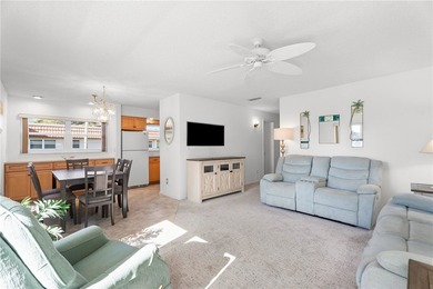 Turnkey 2BR/2BA corner condo in Vista Royale, a desirable 55+ on The American Golf Club in Florida - for sale on GolfHomes.com, golf home, golf lot