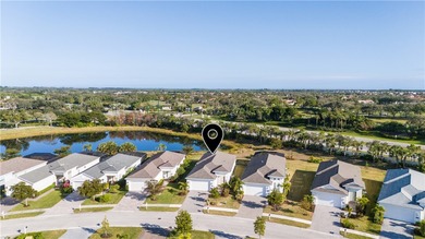 This sophisticated lakefront residence in The Falls at Grand on Oak Harbor Country Club in Florida - for sale on GolfHomes.com, golf home, golf lot