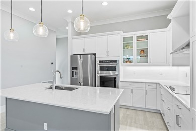 This sophisticated lakefront residence in The Falls at Grand on Oak Harbor Country Club in Florida - for sale on GolfHomes.com, golf home, golf lot