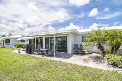 Indulge in the epitome of South Florida living! Imagine waking on Leisureville Community Golf Course in Florida - for sale on GolfHomes.com, golf home, golf lot