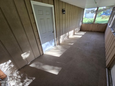 Enjoy golf frontage in your backyard while on the main drag of on Lake Tansi Village Country Club in Tennessee - for sale on GolfHomes.com, golf home, golf lot
