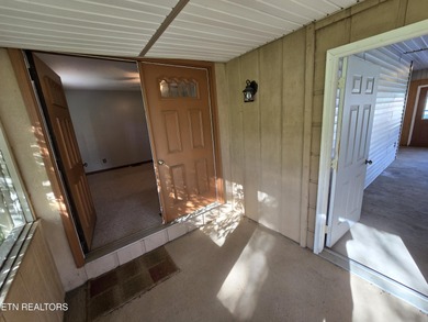Enjoy golf frontage in your backyard while on the main drag of on Lake Tansi Village Country Club in Tennessee - for sale on GolfHomes.com, golf home, golf lot
