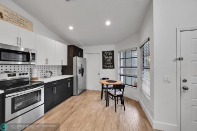 This beautifully and totally updated 2-bed, 2-bath townhouse on Woodmont Country Club in Florida - for sale on GolfHomes.com, golf home, golf lot
