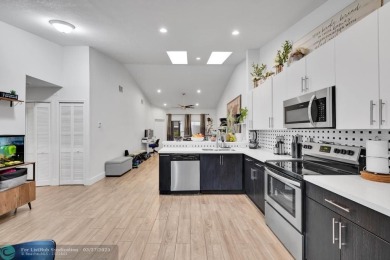 This beautifully and totally updated 2-bed, 2-bath townhouse on Woodmont Country Club in Florida - for sale on GolfHomes.com, golf home, golf lot