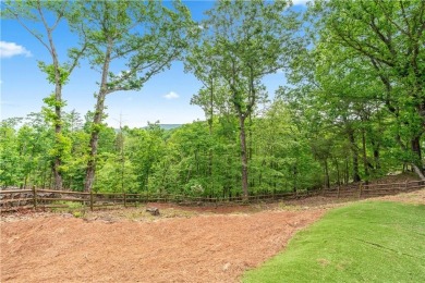 This stunning home offers privacy and views of Lake Arrowhead on The Highlands Course at Lake Arrowhead in Georgia - for sale on GolfHomes.com, golf home, golf lot