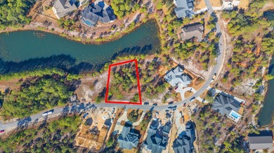 Serene wooded lot with pond in rear. Price includes ARB approved on Sharks Tooth Golf Club in Florida - for sale on GolfHomes.com, golf home, golf lot