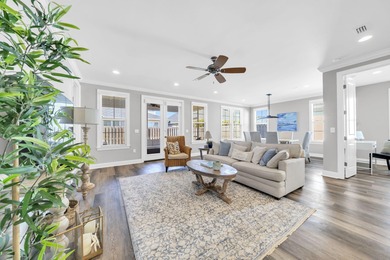 As you arrive at 304 Windrow Way, the corner-lot setting and on Origins Golf Club in Florida - for sale on GolfHomes.com, golf home, golf lot