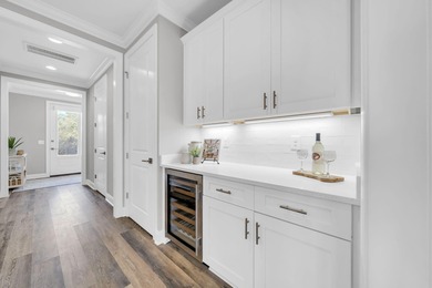 As you arrive at 304 Windrow Way, the corner-lot setting and on Origins Golf Club in Florida - for sale on GolfHomes.com, golf home, golf lot