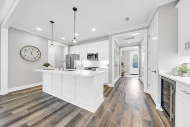 As you arrive at 304 Windrow Way, the corner-lot setting and on Origins Golf Club in Florida - for sale on GolfHomes.com, golf home, golf lot