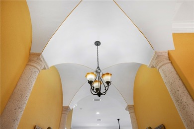 Meticulously landscaped courtyard entry, sculpted gardens and on Bent Pine Golf Club in Florida - for sale on GolfHomes.com, golf home, golf lot