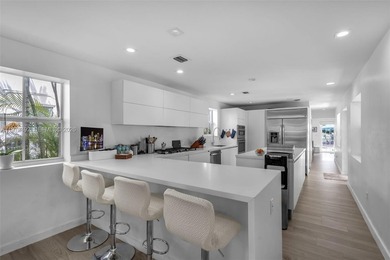 Light-filled and move-in ready, this walled and gated corner-lot on La Gorce Country Club in Florida - for sale on GolfHomes.com, golf home, golf lot