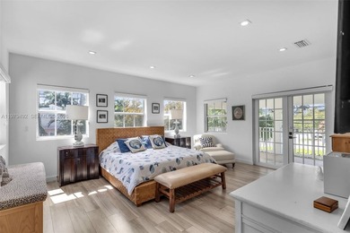 Light-filled and move-in ready, this walled and gated corner-lot on La Gorce Country Club in Florida - for sale on GolfHomes.com, golf home, golf lot