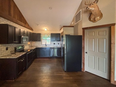 This 3 bedroom, 3 bath home sits on 6 lots in Country Club Hills on Lost Woods Golf Course in Missouri - for sale on GolfHomes.com, golf home, golf lot