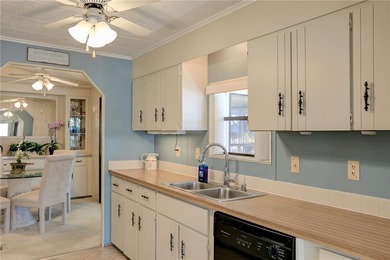 Furnished beauty just steps from the golf course! This on Barefoot Bay Golf Course in Florida - for sale on GolfHomes.com, golf home, golf lot