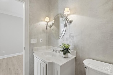 Enjoy panoramic golf course and lagoon views from this beautiful on The Landings Club - Oakridge in Georgia - for sale on GolfHomes.com, golf home, golf lot
