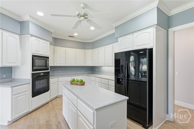 Enjoy panoramic golf course and lagoon views from this beautiful on The Landings Club - Oakridge in Georgia - for sale on GolfHomes.com, golf home, golf lot