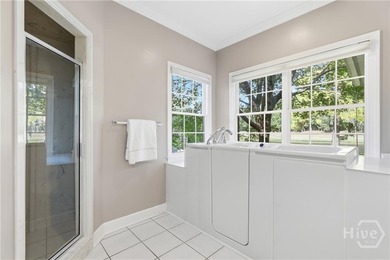 Enjoy panoramic golf course and lagoon views from this beautiful on The Landings Club - Oakridge in Georgia - for sale on GolfHomes.com, golf home, golf lot