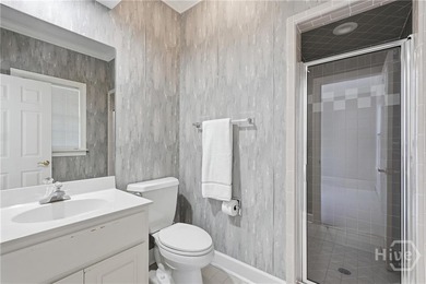 Enjoy panoramic golf course and lagoon views from this beautiful on The Landings Club - Oakridge in Georgia - for sale on GolfHomes.com, golf home, golf lot