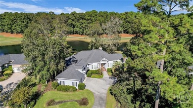 Enjoy panoramic golf course and lagoon views from this beautiful on The Landings Club - Oakridge in Georgia - for sale on GolfHomes.com, golf home, golf lot