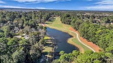 Enjoy panoramic golf course and lagoon views from this beautiful on The Landings Club - Oakridge in Georgia - for sale on GolfHomes.com, golf home, golf lot