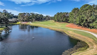 Enjoy panoramic golf course and lagoon views from this beautiful on The Landings Club - Oakridge in Georgia - for sale on GolfHomes.com, golf home, golf lot