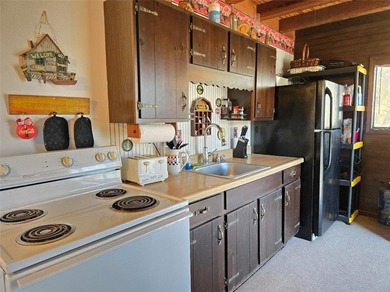 Sugar Valley Lakefront Getaway sits on double lots #79 & #80 on Sugar Valley Lakes Golf Course in Kansas - for sale on GolfHomes.com, golf home, golf lot