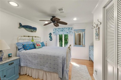 This tropical oasis features an updated interior, lush on Riviera Golf Club in Florida - for sale on GolfHomes.com, golf home, golf lot