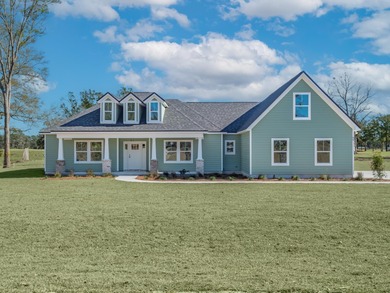 Move-in Ready! Exquisite new construction overlooking hole 6 of on Wildwood Country Club in Florida - for sale on GolfHomes.com, golf home, golf lot