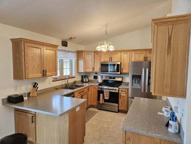 Showings begin 3/15. Beautiful kitchen with solid surface on Saddle Ridge Golf Club in Wisconsin - for sale on GolfHomes.com, golf home, golf lot