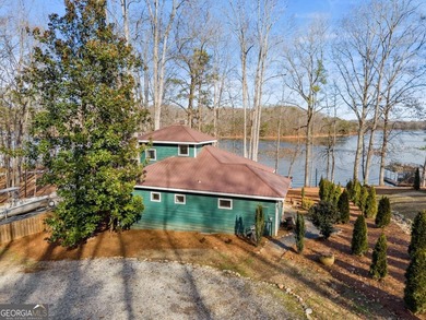 A stone's throw from the water's edge, this lakefront cottage is on Chattahoochee Golf Course in Georgia - for sale on GolfHomes.com, golf home, golf lot