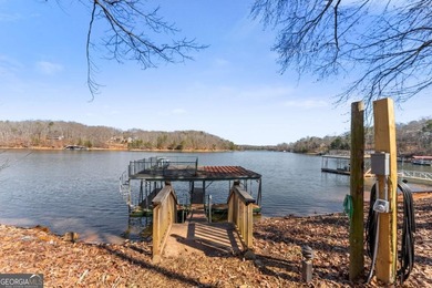 A stone's throw from the water's edge, this lakefront cottage is on Chattahoochee Golf Course in Georgia - for sale on GolfHomes.com, golf home, golf lot