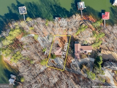 A stone's throw from the water's edge, this lakefront cottage is on Chattahoochee Golf Course in Georgia - for sale on GolfHomes.com, golf home, golf lot