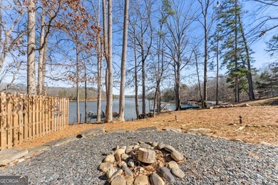 A stone's throw from the water's edge, this lakefront cottage is on Chattahoochee Golf Course in Georgia - for sale on GolfHomes.com, golf home, golf lot