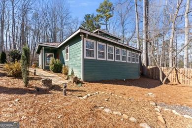 A stone's throw from the water's edge, this lakefront cottage is on Chattahoochee Golf Course in Georgia - for sale on GolfHomes.com, golf home, golf lot