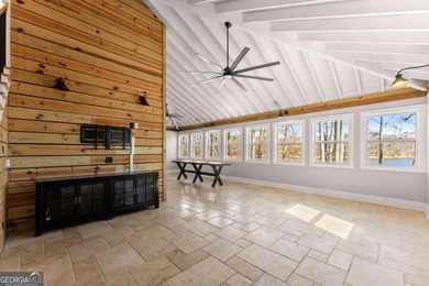 A stone's throw from the water's edge, this lakefront cottage is on Chattahoochee Golf Course in Georgia - for sale on GolfHomes.com, golf home, golf lot