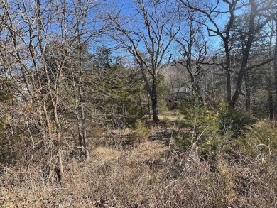 This gently sloping downhill lot would be the perfect spot to on Holiday Island Executive Golf Course in Arkansas - for sale on GolfHomes.com, golf home, golf lot