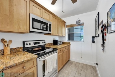 Beautiful condo in Pine Island Ridge's Poinciana community with on Pine Island Ridge Country Club in Florida - for sale on GolfHomes.com, golf home, golf lot